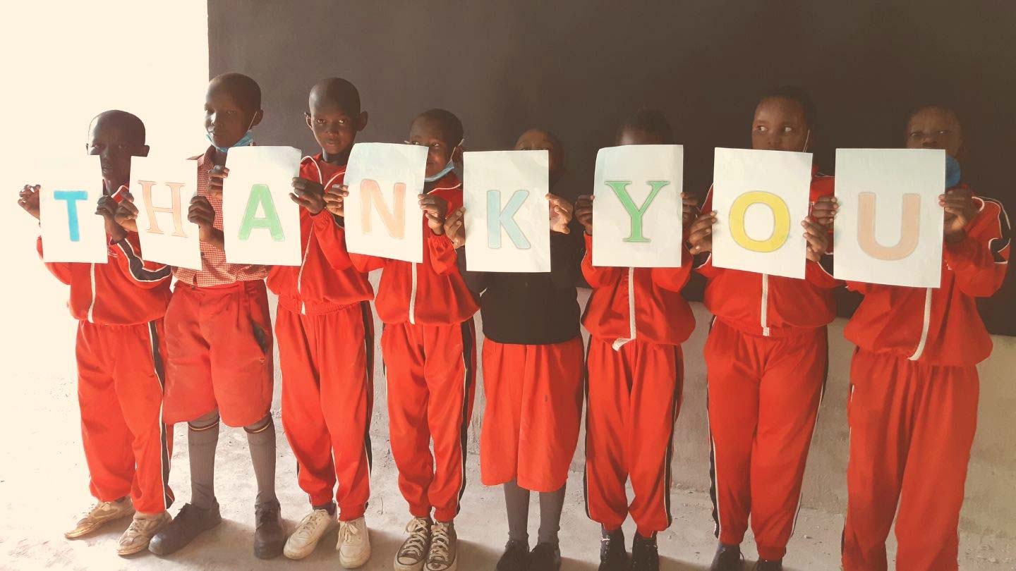 Children holding a Thank You sign