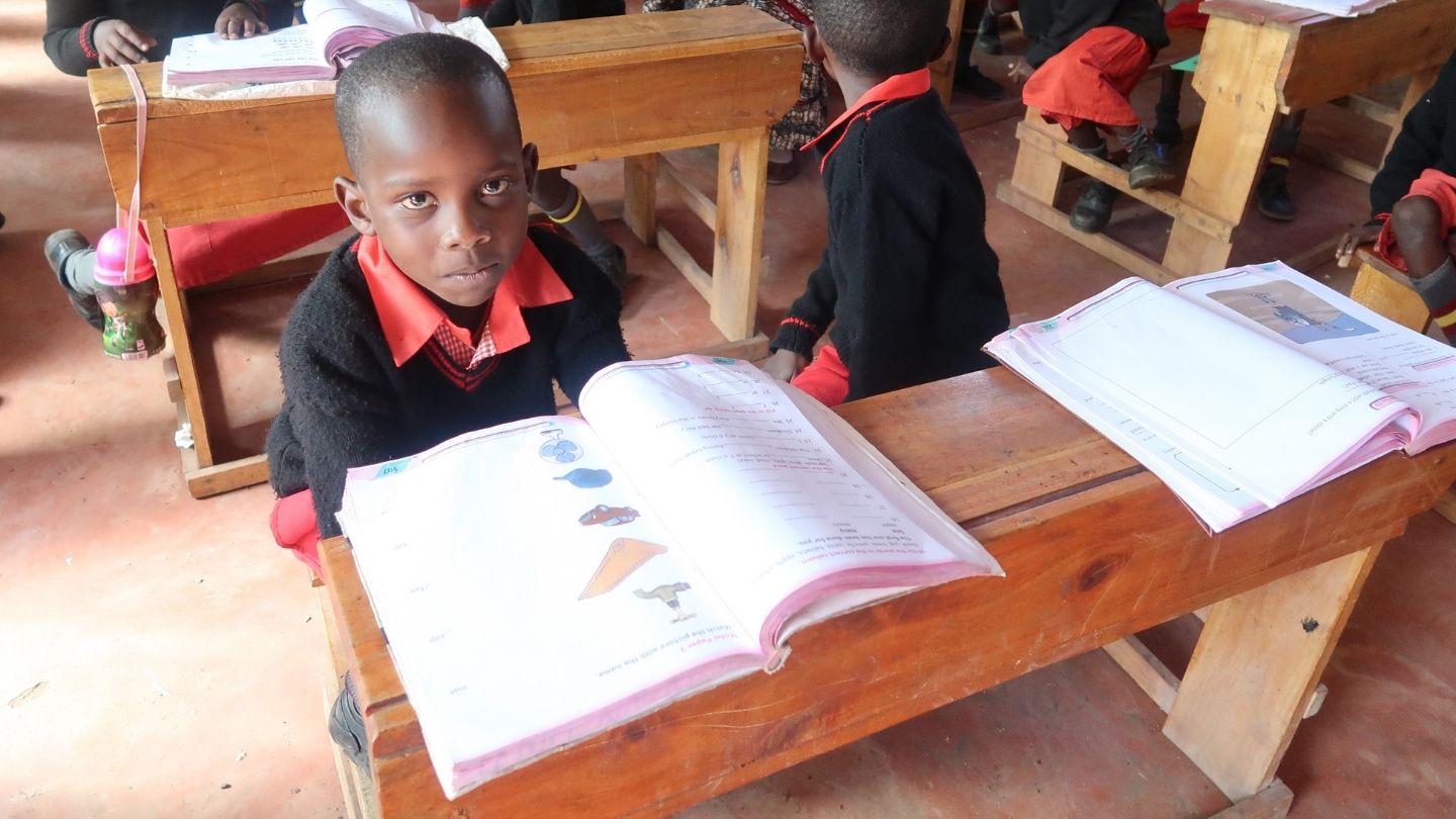 Kenyan child sitting at desk